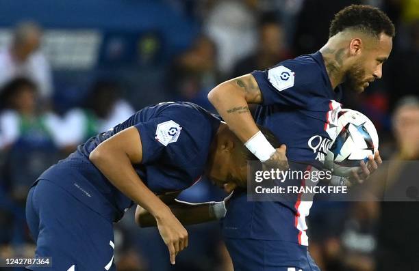 Paris Saint-Germain's Brazilian forward Neymar celebrates with Paris Saint-Germain's French forward Kylian Mbappe after scoring his team's first goal...