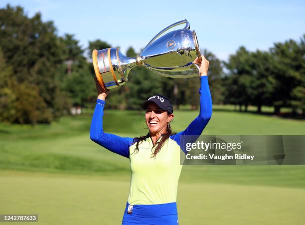 Paula Reto of South Africa celebrates with the championship trophy following the final round of the CP Women's Open at Ottawa Hunt and Golf Club on...