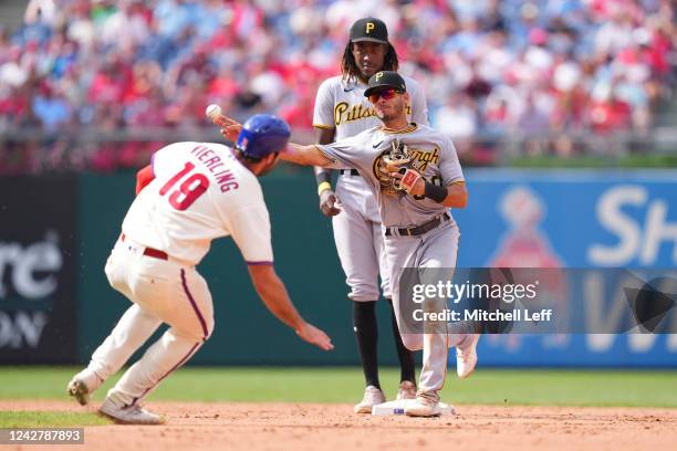 Tucupita Marcano of the Pittsburgh Pirates turns a double play against Matt Vierling of the Philadelphia Phillies in the bottom of the seventh inning...