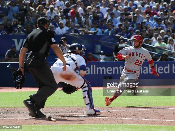 August 28 - Los Angeles Angels shortstop David Fletcher is safe at home in the 7th as Toronto Blue Jays catcher Danny Jansen can't catch up to him...