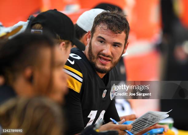 Mitch Trubisky of the Pittsburgh Steelers talks with teammates during the first quarter against the Detroit Lions at Acrisure Stadium on August 28,...