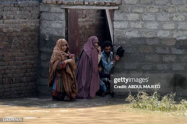 Stranded residents prepare to leave their flooded home following heavy monsoon rains in Charsadda district of Khyber Pakhtunkhwa on August 29, 2022....