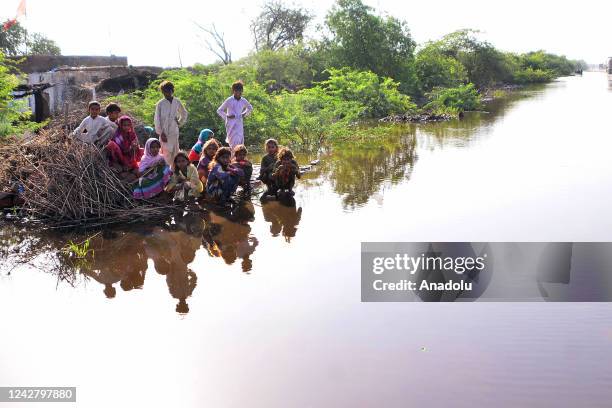 Pakistani flood victims are seen at a safer place surrounded by floodwater in Matiari, Sindh province, Pakistan on August 29, 2022.