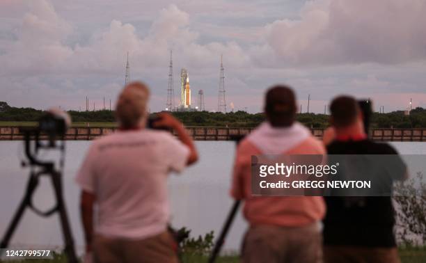Press photographers set up to over the Artemis I Space Launch System rocket mission at the Kennedy Space Center in Florida on August 29, 2022. -...