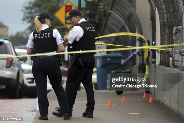 Chicago police officers guard a crime scene after a shooting at the CTA Red Line station at 79th Street on Aug. 8, 2022.