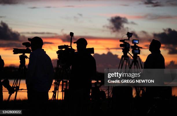 News media prepare to cover the Artemis I Space Launch System rocket mission just before dawn at the Kennedy Space Center in Florida on August 29,...
