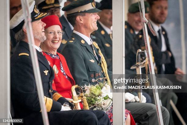 Queen Margrethe II of Denmark is flanked by her sons Crown Prince Frederik of Denmark and Prince Joachim of Denmark as she attends festivities of the...