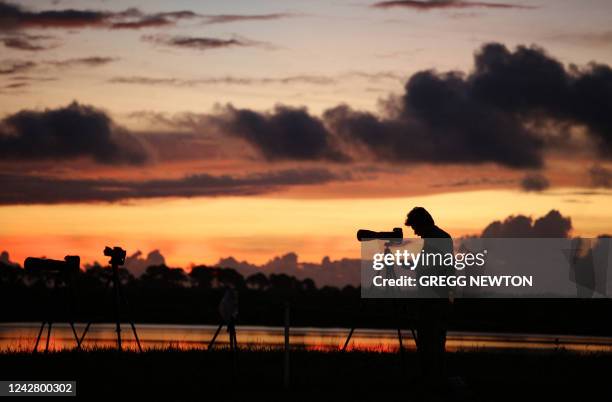 Press photographer sets up to cover the Artemis I Space Launch System rocket mission, at just under two hours before launch at the Kennedy Space...
