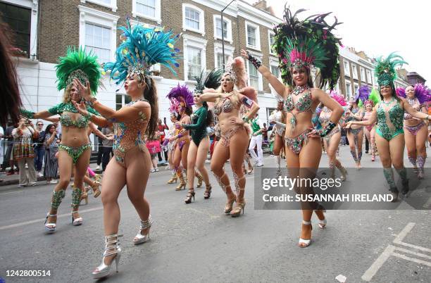 Performers in costume take part in the carnival on the main Parade day of the Notting Hill Carnival in west London on August 29, 2022. - London's...