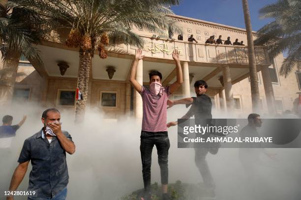 Supporters of Iraqi Shiite cleric Moqtada Sadr gather outside and on the balcony of the Government Headquarters in the capital Baghdad's Green Zone,...