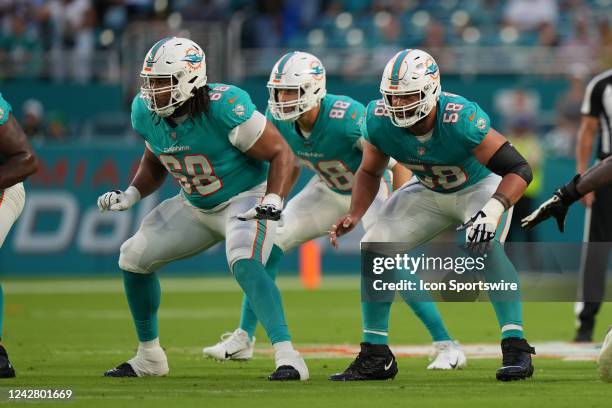 Miami Dolphins offensive tackle Robert Hunt , Miami Dolphins guard Connor Williams and Miami Dolphins tight end Mike Gesicki protest the right side...