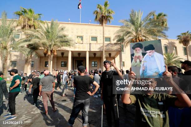 Supporters of Iraqi Shiite cleric Moqtada Sadr gather outside the Government Headquarters in the capital Baghdad's Green Zone, on August 29, 2022. -...