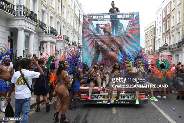Performers in costume take part in the carnival on the main Parade day of the Notting Hill Carnival in west London on August 29, 2022. - London's...