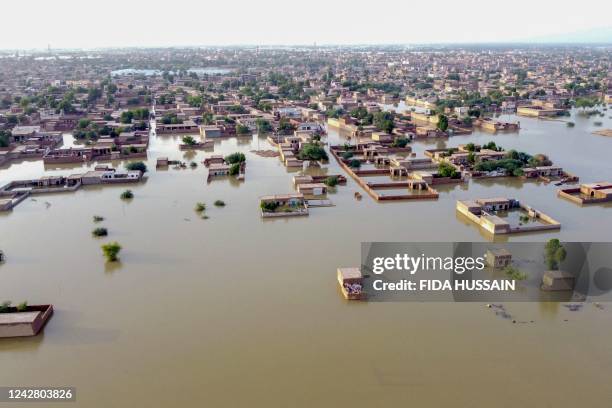 This aerial view shows a flooded residential area after heavy monsoon rains in Balochistan province on August 29, 2022. - The death toll from monsoon...