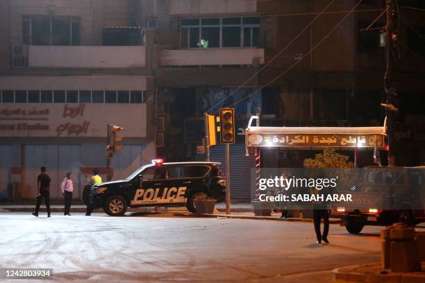 An Iraqi security vehicle patrols a street in the capital Baghdad on August 29 after a full curfew was announced by the Iraqi army. - Angry...