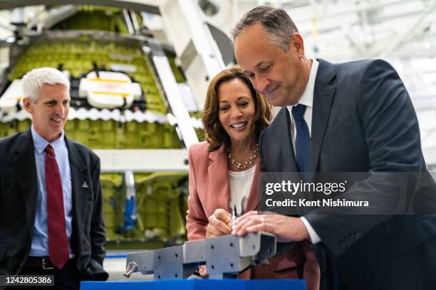 Vice President Kamala Harris watches Second Gentleman Doug Emhoff sign a piece of Artemis III hardware during a tour at the High Bay Operations and...