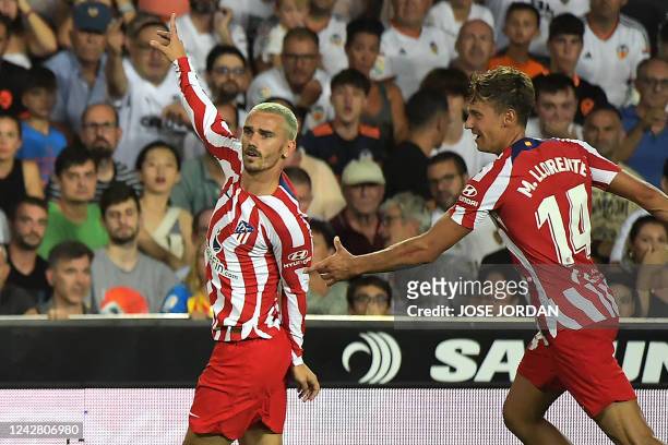 Atletico Madrid's French forward Antoine Griezmann celebrates scoring his team's first goal during the Spanish League football match between Valencia...