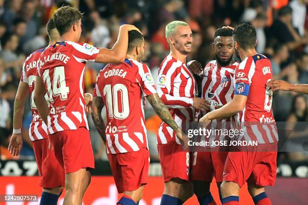 Atletico Madrid's French forward Antoine Griezmann , Atletico Madrid's French midfielder Thomas Lemar and teammates celebrate their win at the end of...