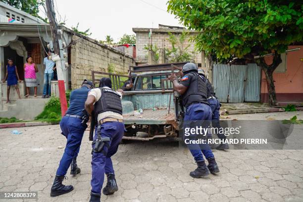 Police remove a truck which had been used as a barricade following a violent demonstration which caused 2 deaths in Petit-Goave in southern Haiti on...