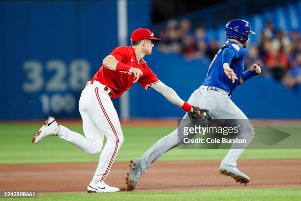 Cavan Biggio of the Toronto Blue Jays tags Ian Happ of the Chicago Cubs in a rundown during the first inning at Rogers Centre on August 29, 2022 in...