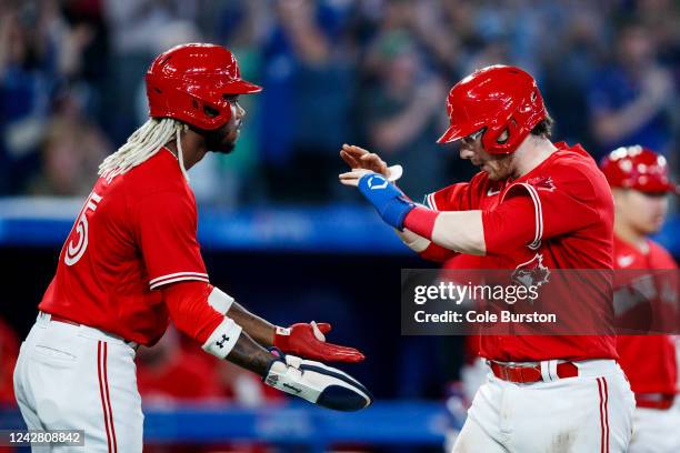 Danny Jansen and Raimel Tapia of the Toronto Blue Jays celebrate Jansen's three-run home run in the seventh inning against the Chicago Cubs at Rogers...