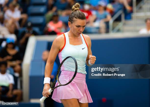 Simona Halep of Romania celebrates winning a point against Daria Snigur of Ukraine in her first round match on Day 1 of the US Open Tennis...