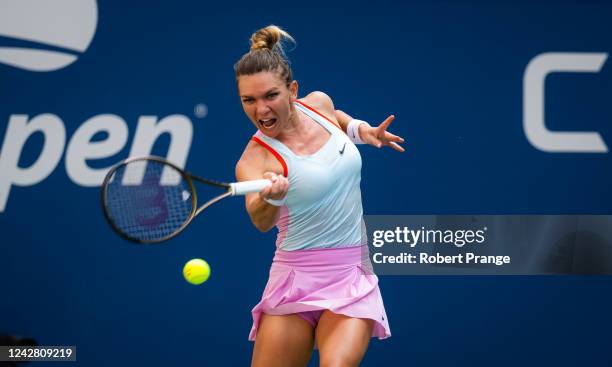 Simona Halep of Romania hits a shot against Daria Snigur of Ukraine in her first round match on Day 1 of the US Open Tennis Championships at USTA...