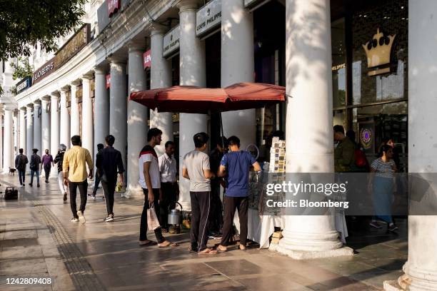 People gather at a mobile accessory shop in Connaught Place in New Delhi, India, on Saturday, Aug. 27, 2022. India is scheduled to release...