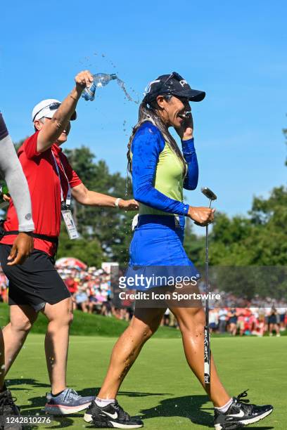 Paula Reto is drenched with champagne by other players after sinking her par putt on 18 to win the 2022 CP Women's Open at the Ottawa Hunt and Golf...