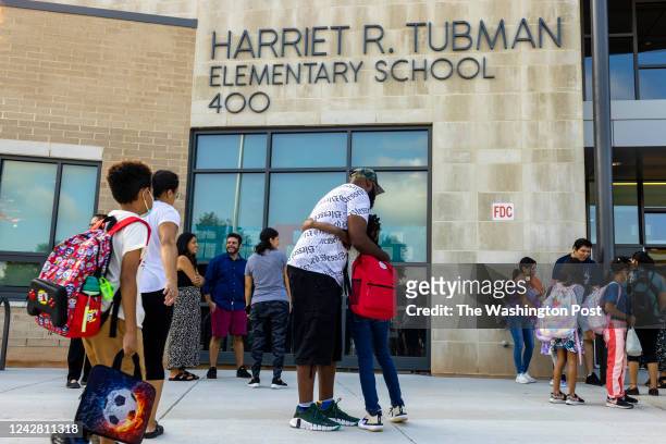 Parent and child hug on the first day of school at the new Harriet Tubman Elementary School in Gaithersburg, MD on August 2022.