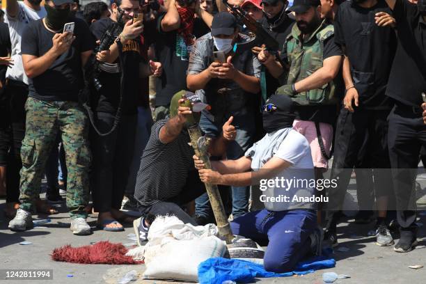 Supporters of Iraqi cleric Muqtada al-Sadr clash with security forces with heavy weapons at Green Zone after Sadr supporters stormed the Presidential...