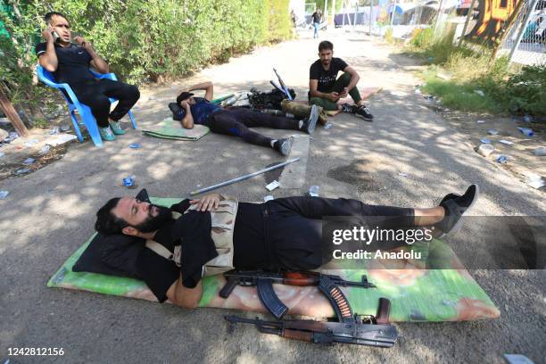 Supporters of Iraqi cleric Muqtada al-Sadr rest as they clash with security forces with heavy weapons at Green Zone after Sadr supporters stormed the...