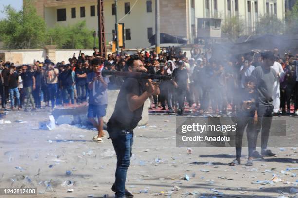 Supporters of Iraqi cleric Muqtada al-Sadr clash with security forces with heavy weapons at Green Zone after Sadr supporters stormed the Presidential...