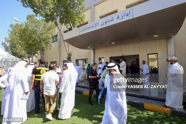 Kuwaiti candidates arrive to register for the upcoming parliamentary election at the electoral department in Kuwait City on August 30 ahead of the...