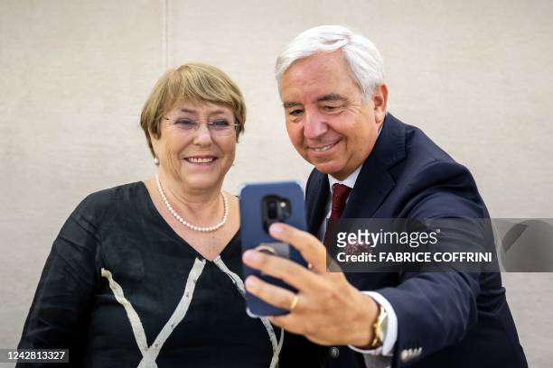 Outgoing UN High Commissioner Michelle Bachelet poses for a selfie with the UN Human Rights Council President Federico Villegas during a farewell at...