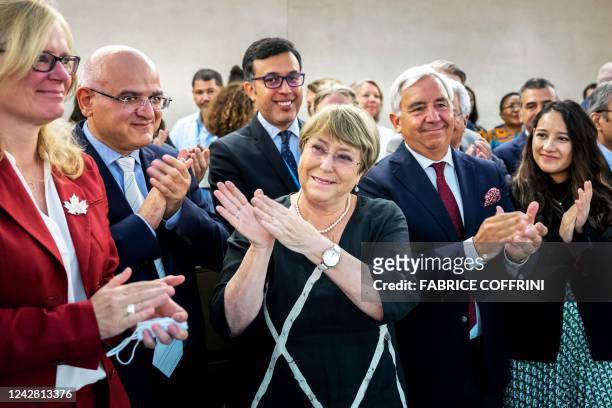 Outgoing UN High Commissioner Michelle Bachelet is greeted by the representatives during a farewell at the preparatory meeting for the next regular...