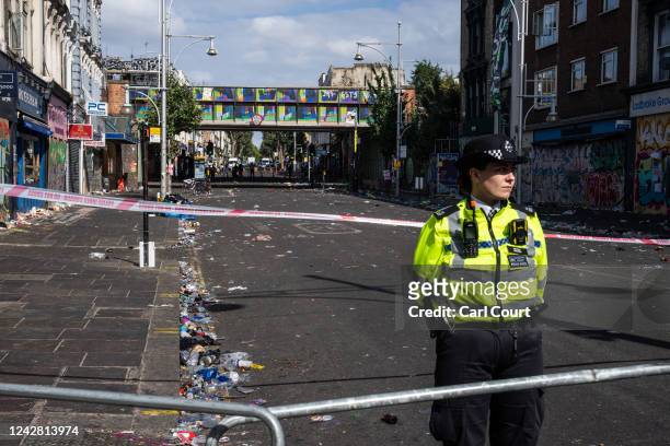 Police officer stands by the cordon at the scene of yesterday's fatal stabbing during the Notting Hill Carnival, on August 30, 2022 in the Ladbroke...