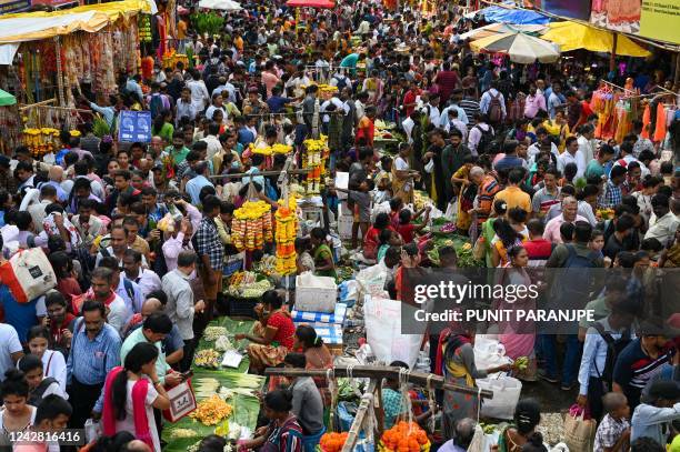 People throng a wholesale flower market ahead of the Ganesh Chaturthi festival in Mumbai on August 30, 2022.