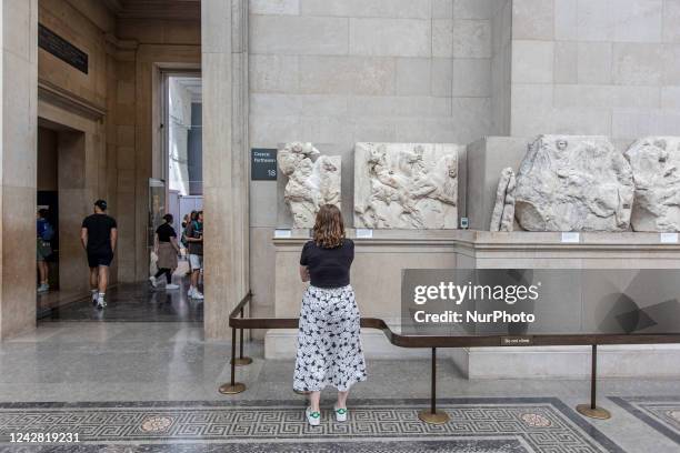 People admire the Parthenon Marbles inside the Parthenon Galleries in the British Museum. The marbles are also known as Elgin Marbles, with...