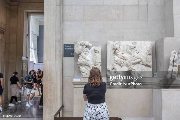 People admire the Parthenon Marbles inside the Parthenon Galleries in the British Museum. The marbles are also known as Elgin Marbles, with...