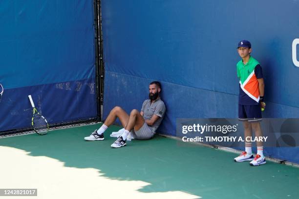 Benoit Paire from France sits during a medical emergency in the stands during his match against Cameron Norris from Great Britain during their first...