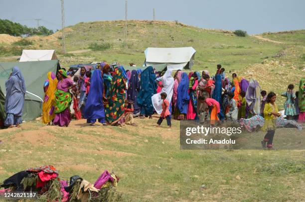 Flood affected women's are staging outside there tents at Ganjo Takar relief camp here in Hyderabad on August 30, 2022.