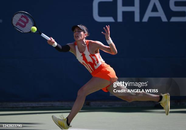 Germany's Andrea Petkovic hits a return to Switzerland's Belinda Bencic during their 2022 US Open Tennis tournament women's singles first round match...
