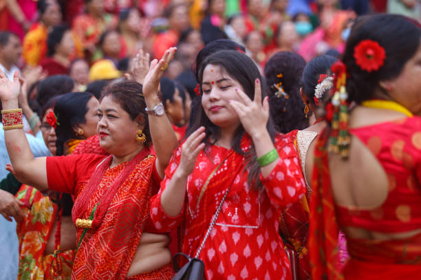 Nepalese Hindu women sing and dance after paying homage to Lord Shiva, the Hindu god of destruction at the premises of Pashupatinath Temple during...