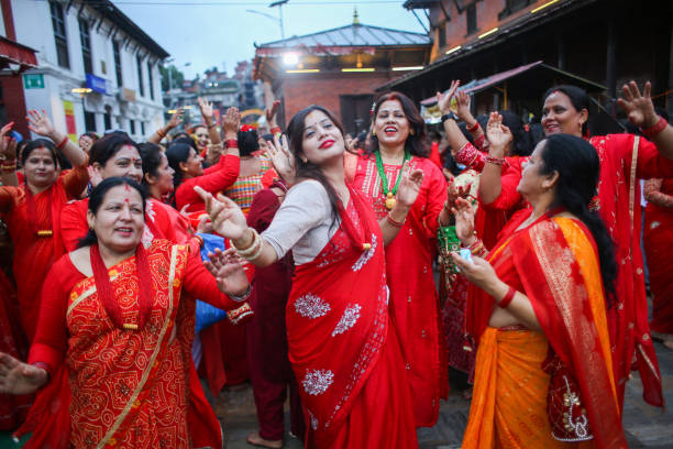Nepalese Hindu women sing and dance after paying homage to Lord Shiva, the Hindu god of destruction at the premises of Pashupatinath Temple during...