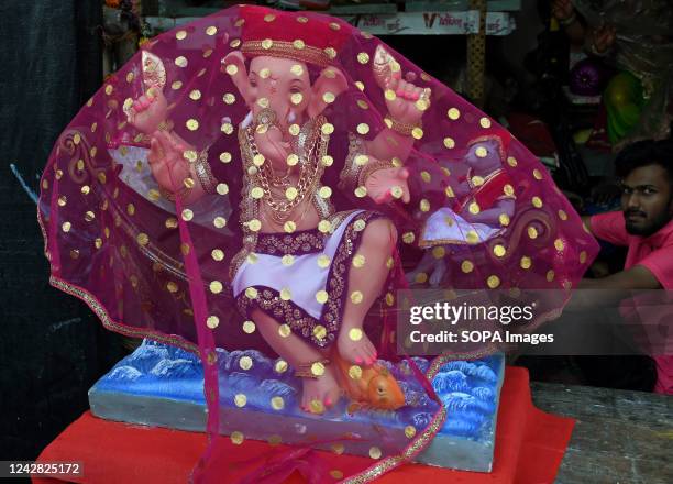 Idol of elephant headed Hindu god Ganesh covered with a cloth is ready to be carried home by devotees ahead of Ganesh Chaturthi. The 10 days festival...