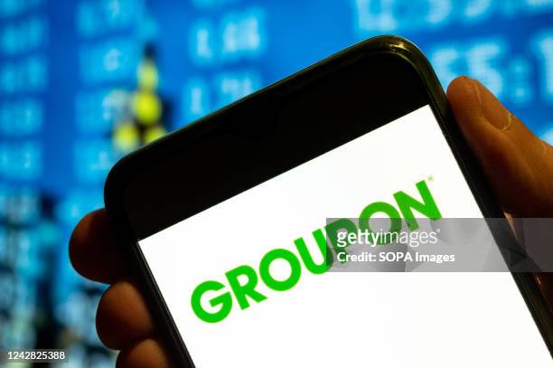 In this photo illustration, the American worldwide e-commerce marketplace Groupon logo is displayed on a smartphone screen.