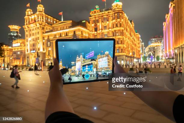 Citizens experience the city digital twin app based on the metaverse concept at the Bund in Shanghai, China, Aug 30, 2022. The Fifth World Conference...