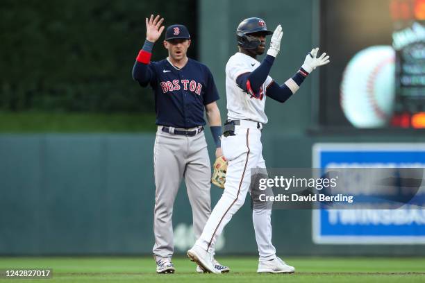 Nick Gordon of the Minnesota Twins celebrates his two RBI double as Trevor Story of the Boston Red Sox looks on in the first inning at Target Field...