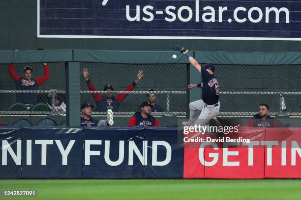 Enrique Hernandez of the Boston Red Sox jumps but can't catch a ball hit by Jose Miranda of the Minnesota Twins for a double in the third inning at...